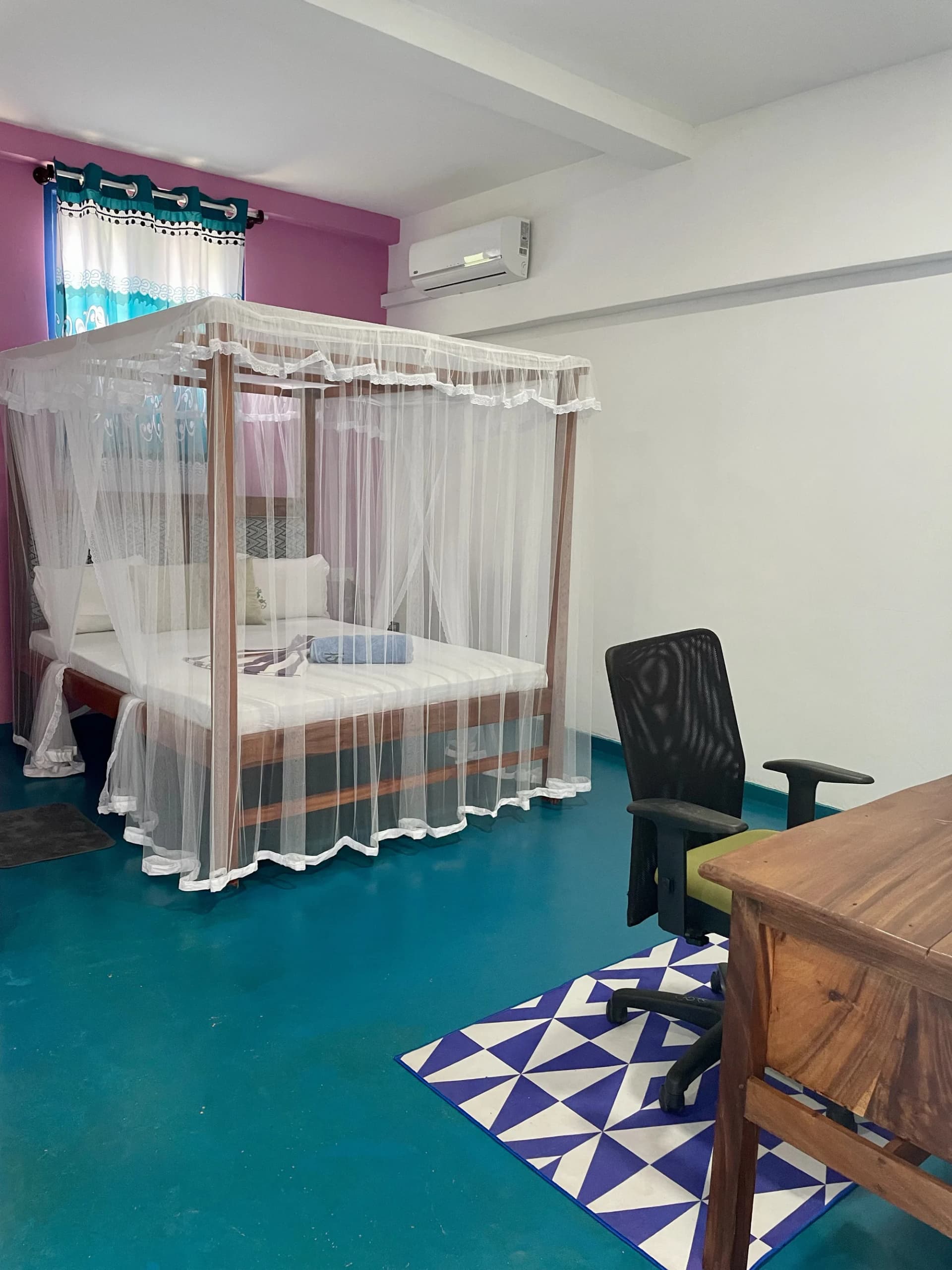 Canopy four-poster bed with mosquito net at Anu Villa