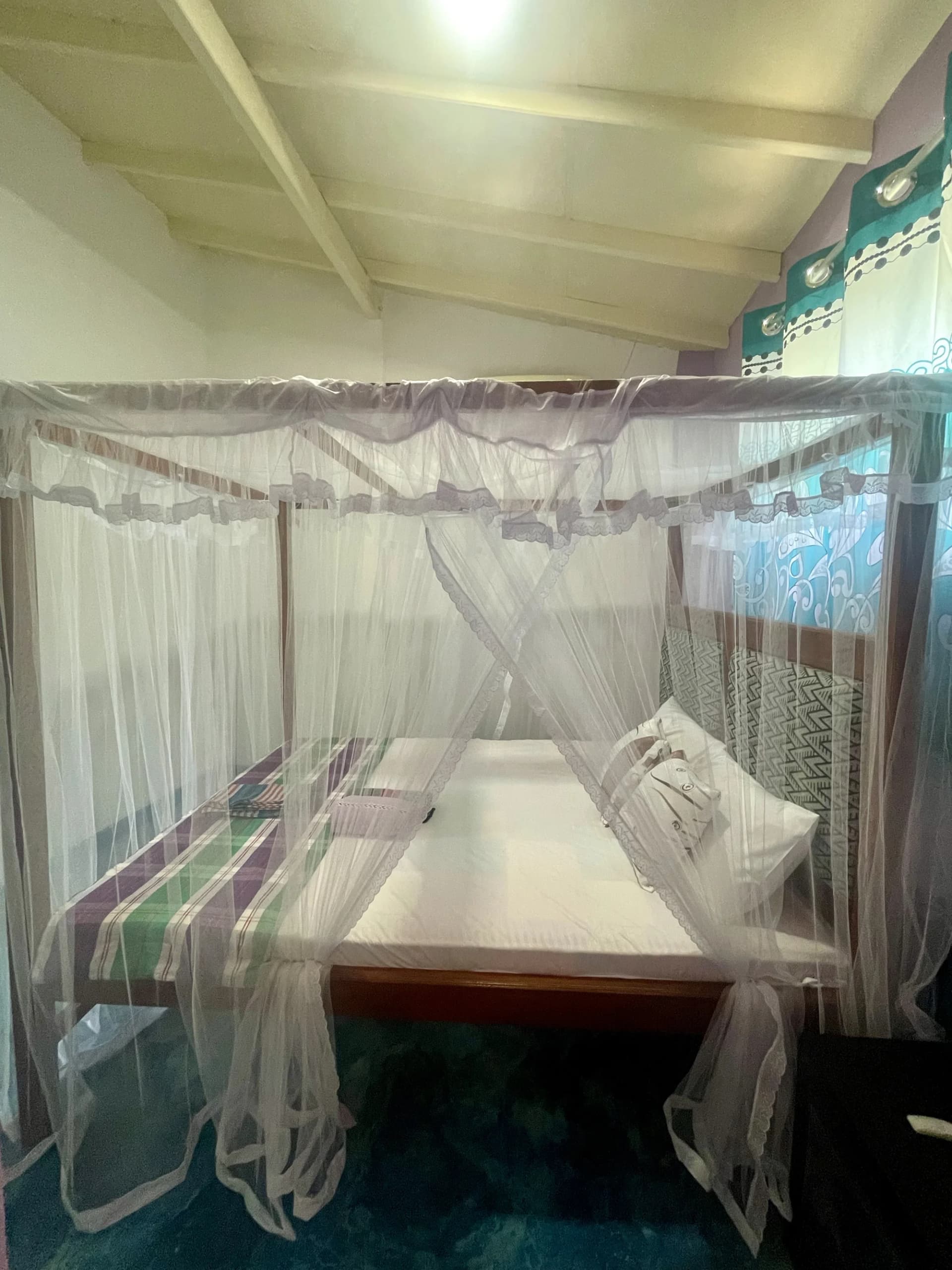 Apartment 2 king bed with netting and timber beams