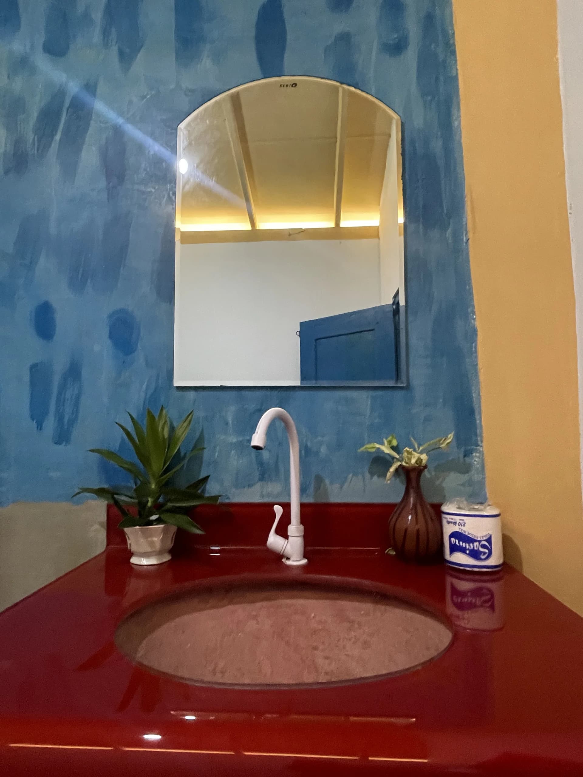 Artisan washbasin and mirror detail in en-suite bathroom